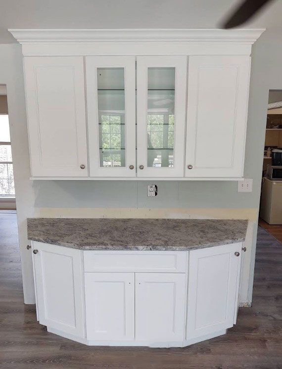 White kitchen cabinets with a countertop.