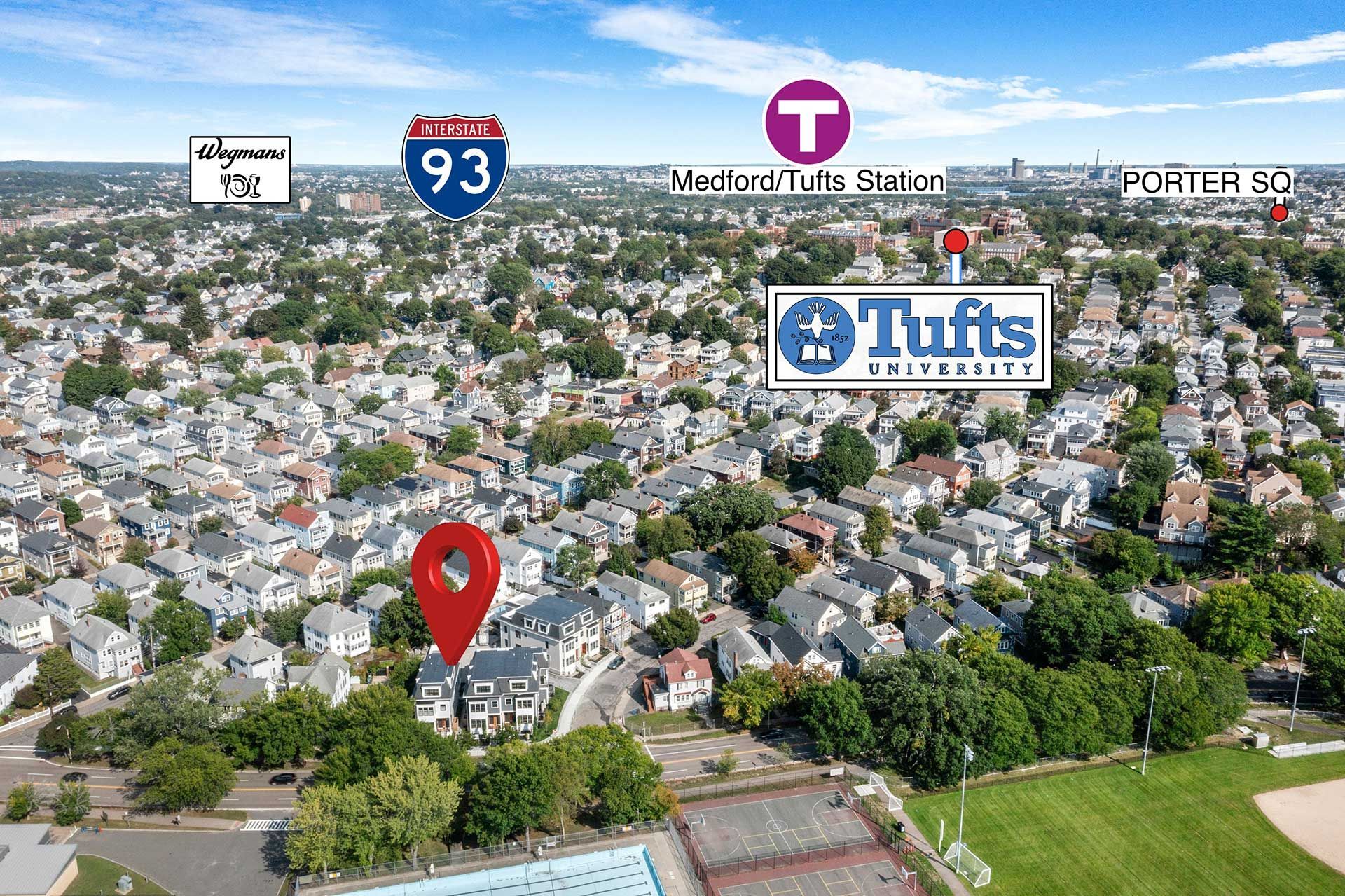 Aerial view of houses with a red location marker, near Tufts University, highway, and public transportation.