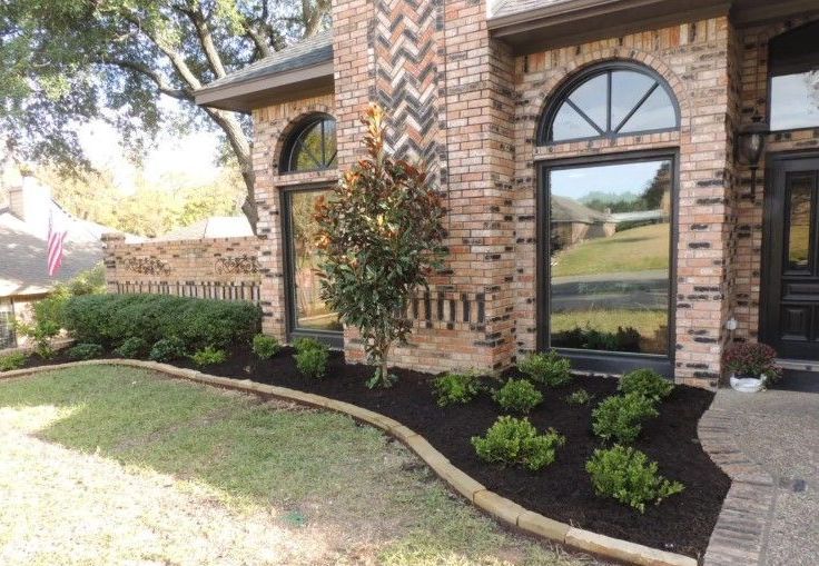 A bunch of rolls of grass are sitting on top of a lush green lawn.