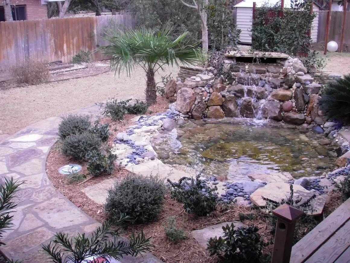 A pond with a waterfall in the middle of it