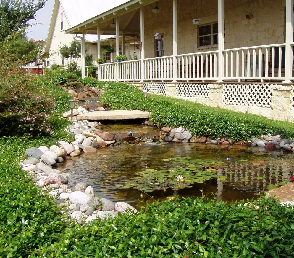 A stone wall with a grill and a fireplace built into it