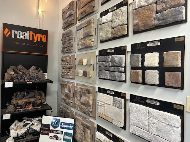 Wall display of stone veneer samples with a fireplace display in a showroom.