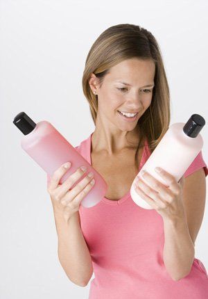 Woman holding hair care products