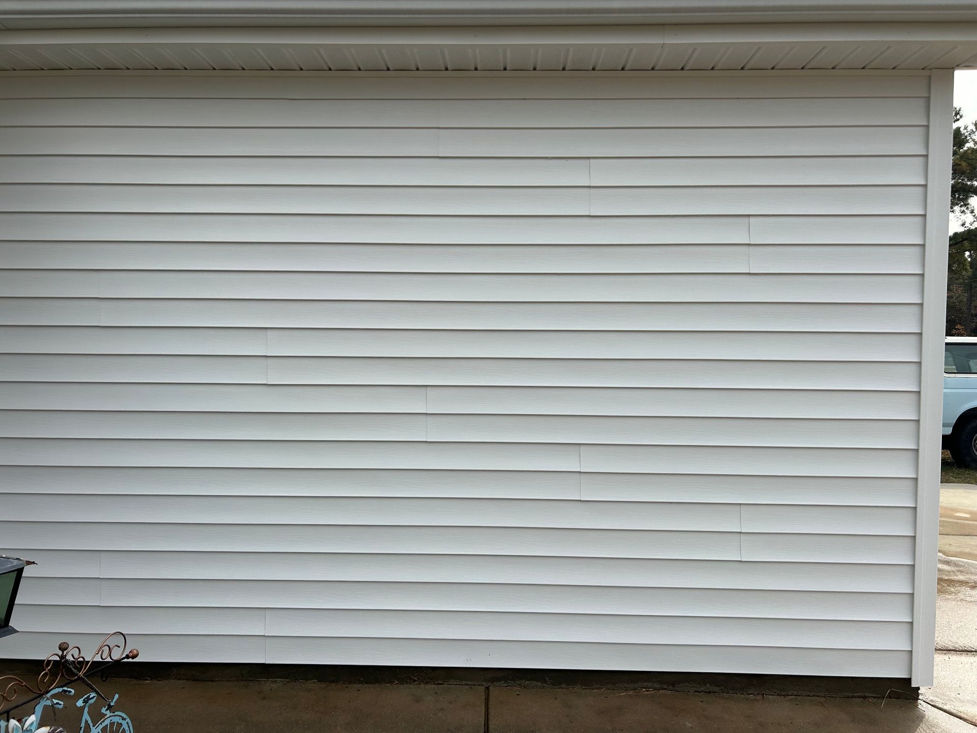 White siding on a building with wavy distortions.