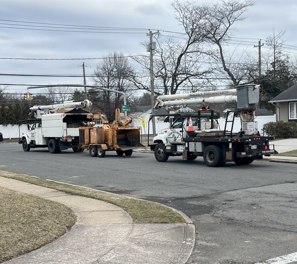 A couple of trucks are parked on the side of the road.