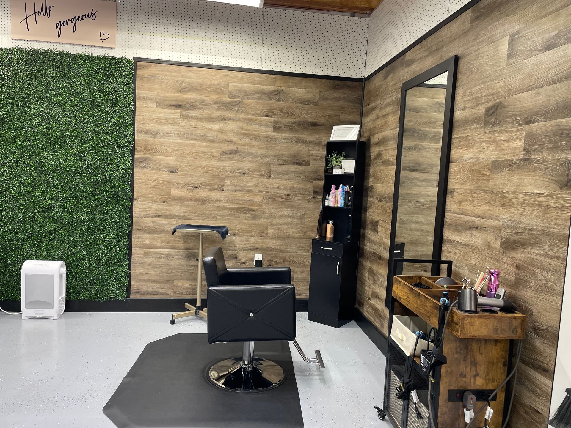 A hair salon with a chair and two mirrors.