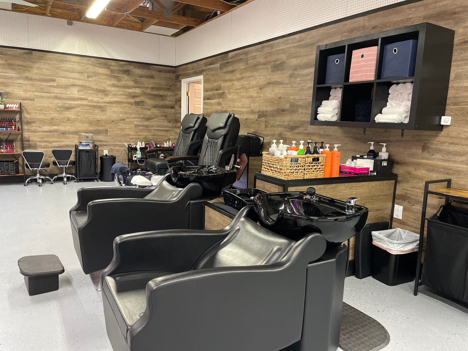 A hair salon with two chairs and a sink.