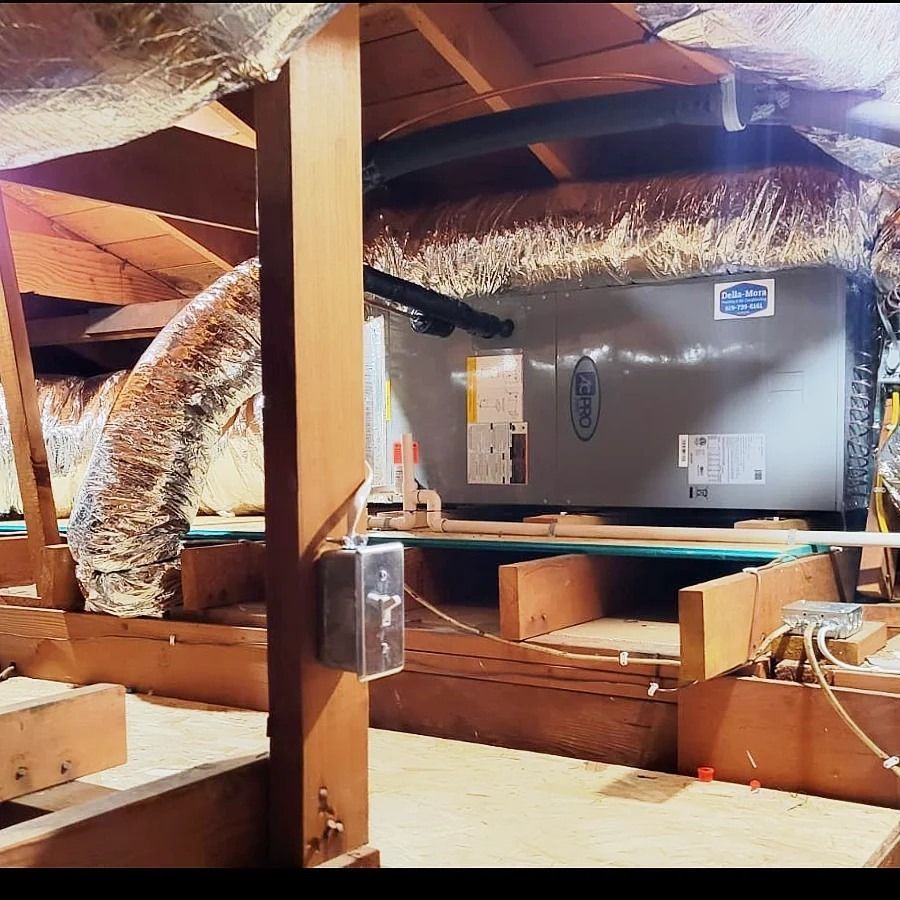HVAC system in an attic. Ductwork, Lennox unit, electrical components visible. Wooden structure.
