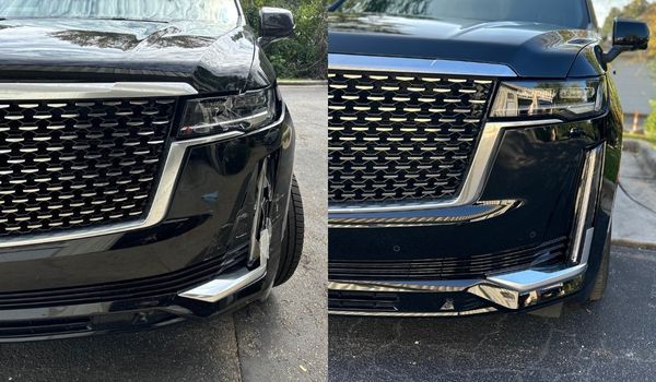 Two black SUVs, one damaged on the left side. Both have chrome grilles and headlights.