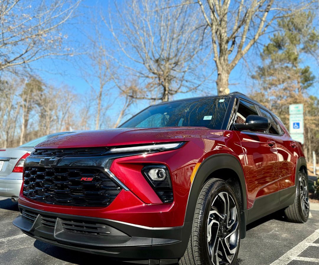 Red Chevrolet Blazer RS SUV parked outside on a sunny day.