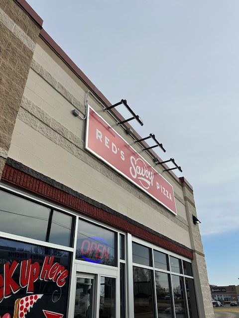 Red's Sausage & Pizza restaurant with red sign, 