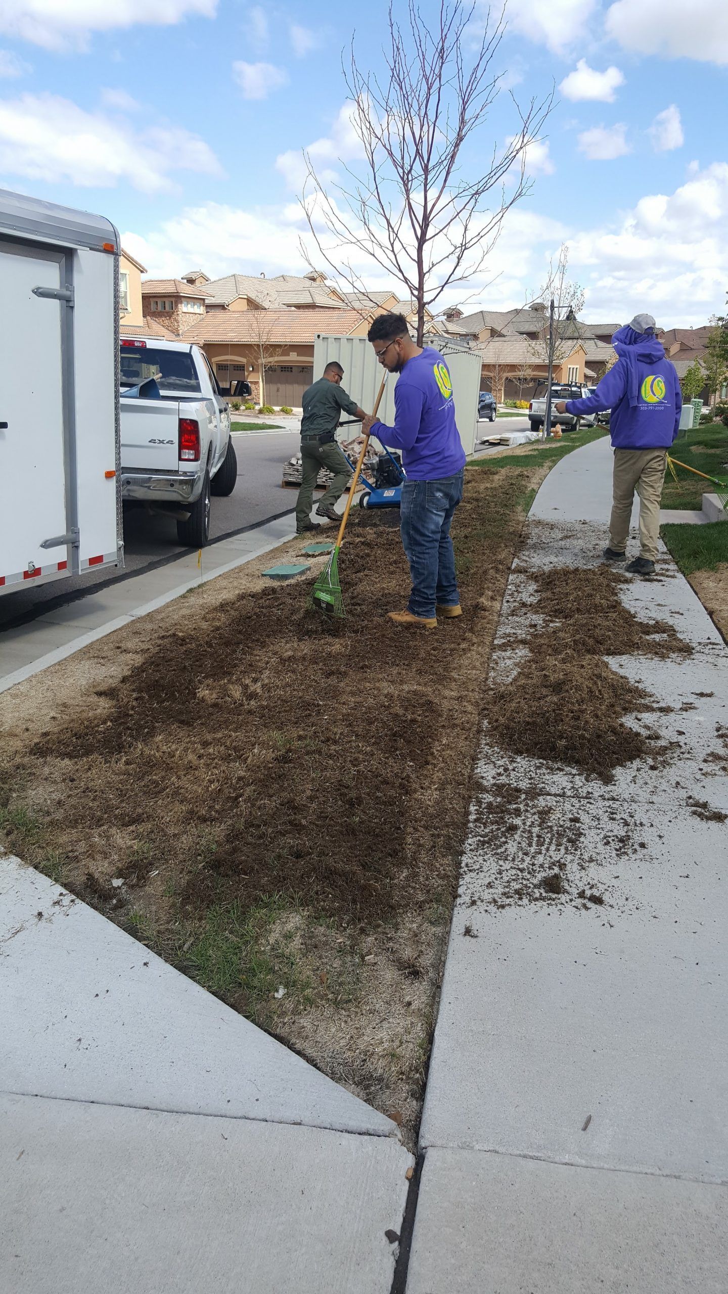 A group of people are working on a sidewalk.