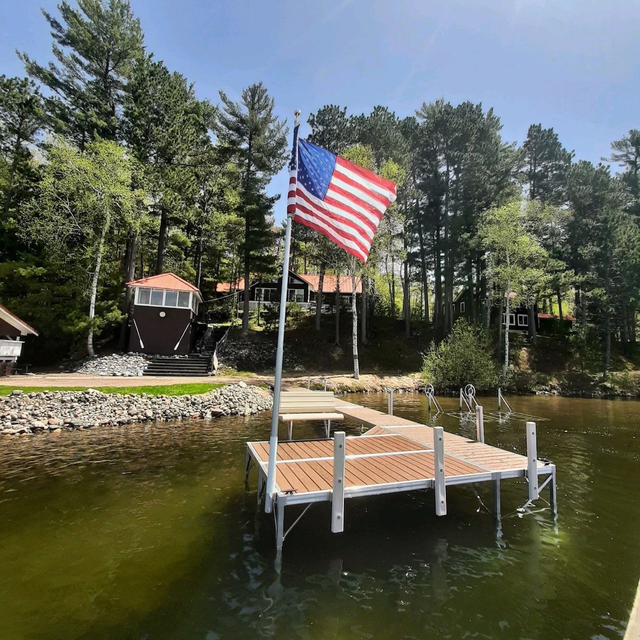 dock by the lake with an American flag