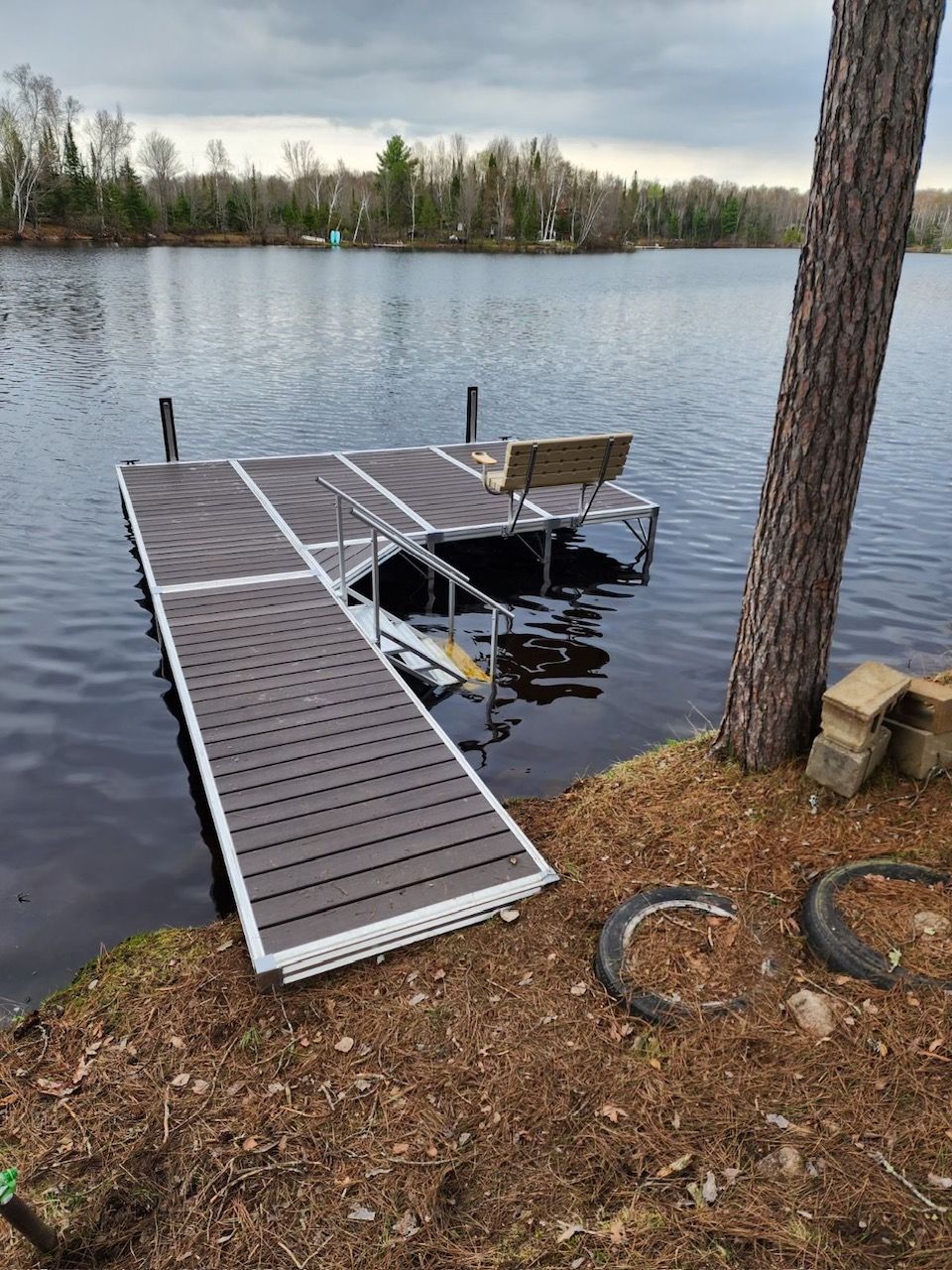 dock by the lake with bench