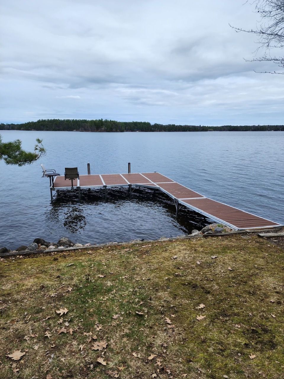 wooden dock by the lake with a bench