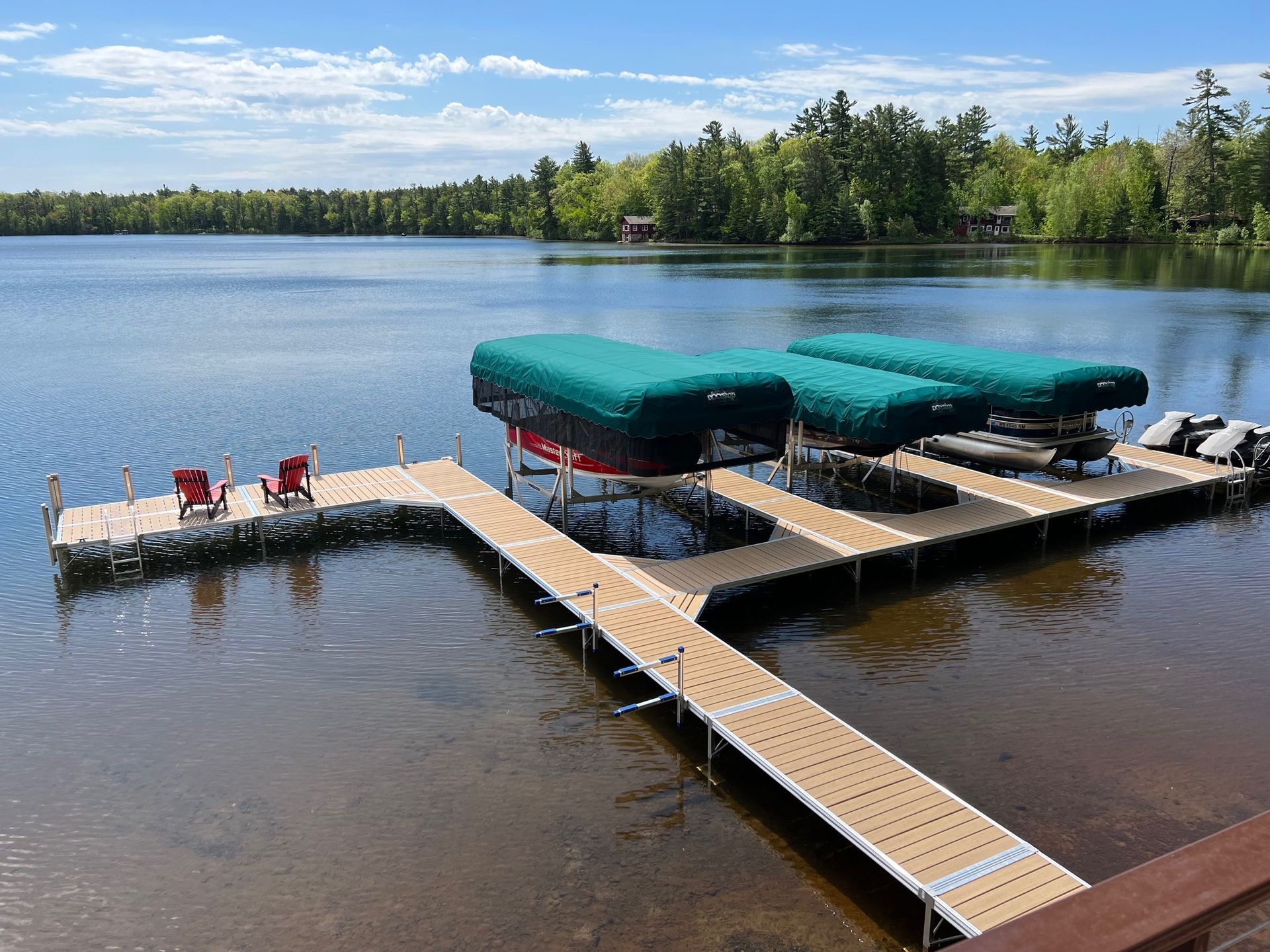dock by the lake with 3 covered boats