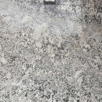 Granite countertop with a mottled pattern of white, gray, and black speckles.