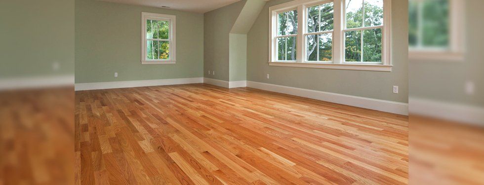 wide empty room with wooden floor