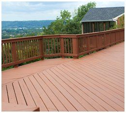 A freshly painted and stained wood deck with railing