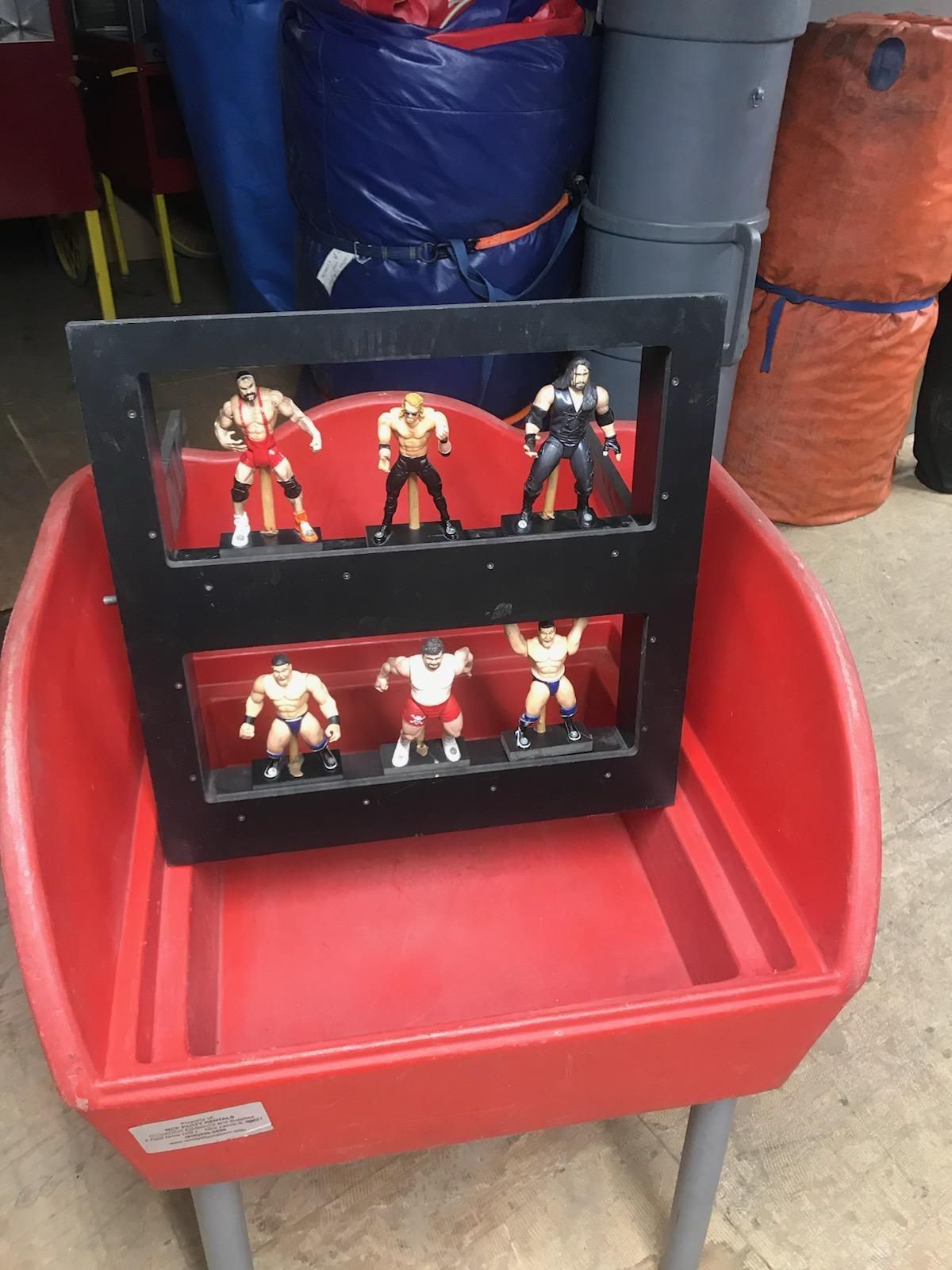 A red table with a display of wrestlers on it