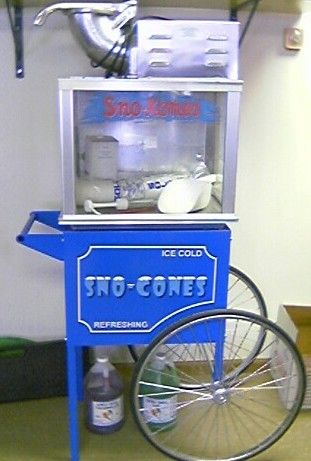 A snow cone machine is sitting on top of a blue cart