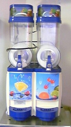 A couple of blenders that are sitting next to each other on a table.