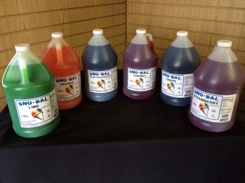 A table topped with bottles of different colored liquids.