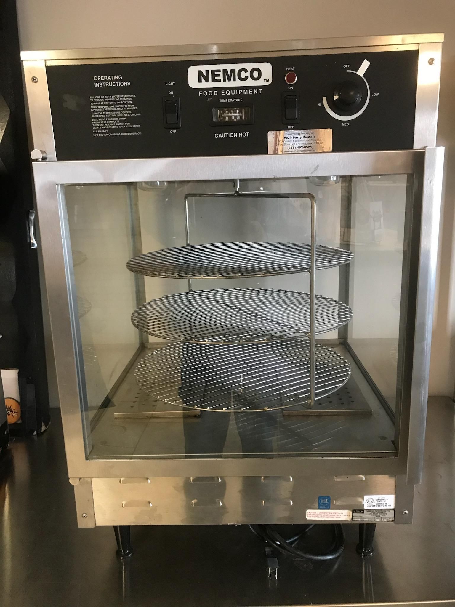 A stainless steel display case with plates inside of it.