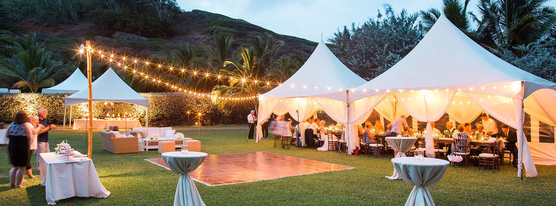 A group of tents are sitting on top of a lush green field.