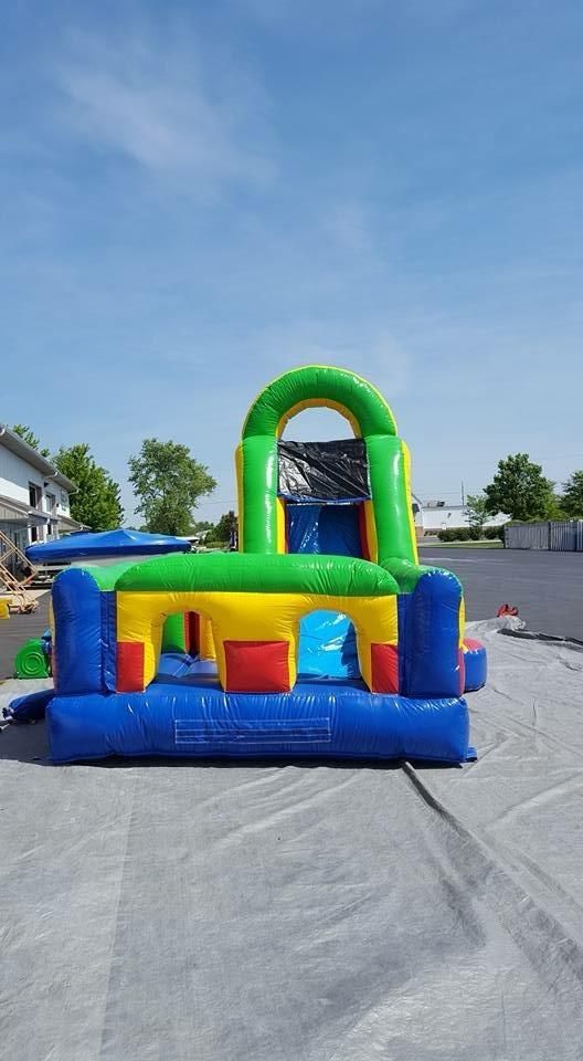 A large inflatable bouncy house is sitting on the ground in a parking lot.