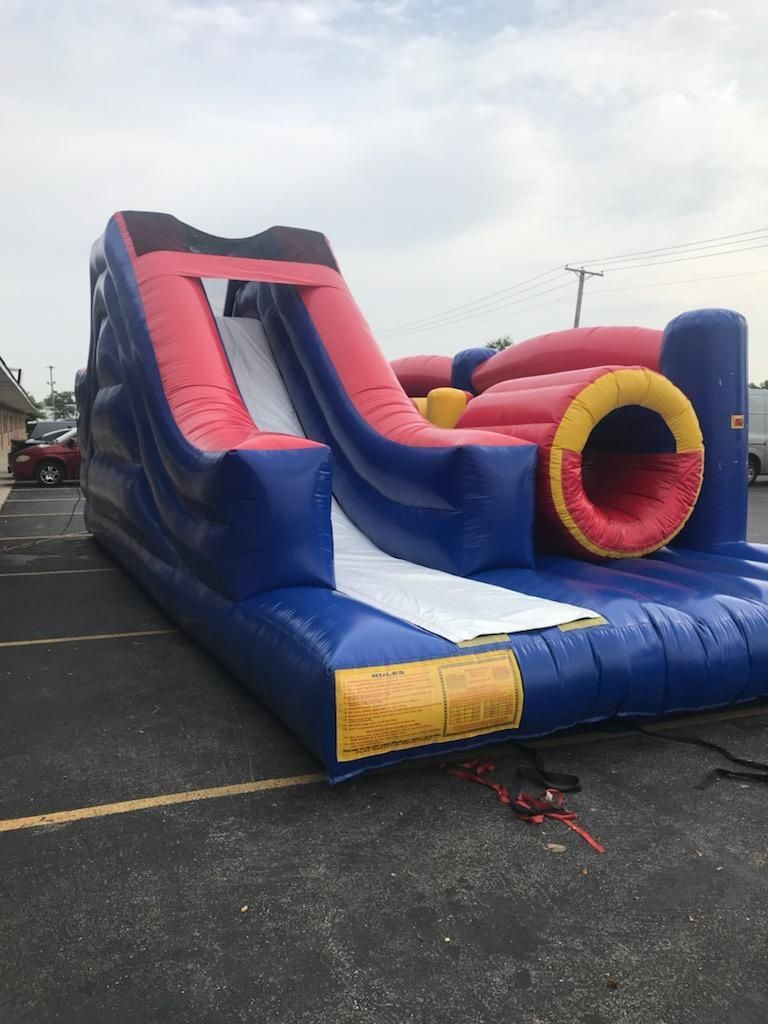 A large inflatable slide is sitting in a parking lot.