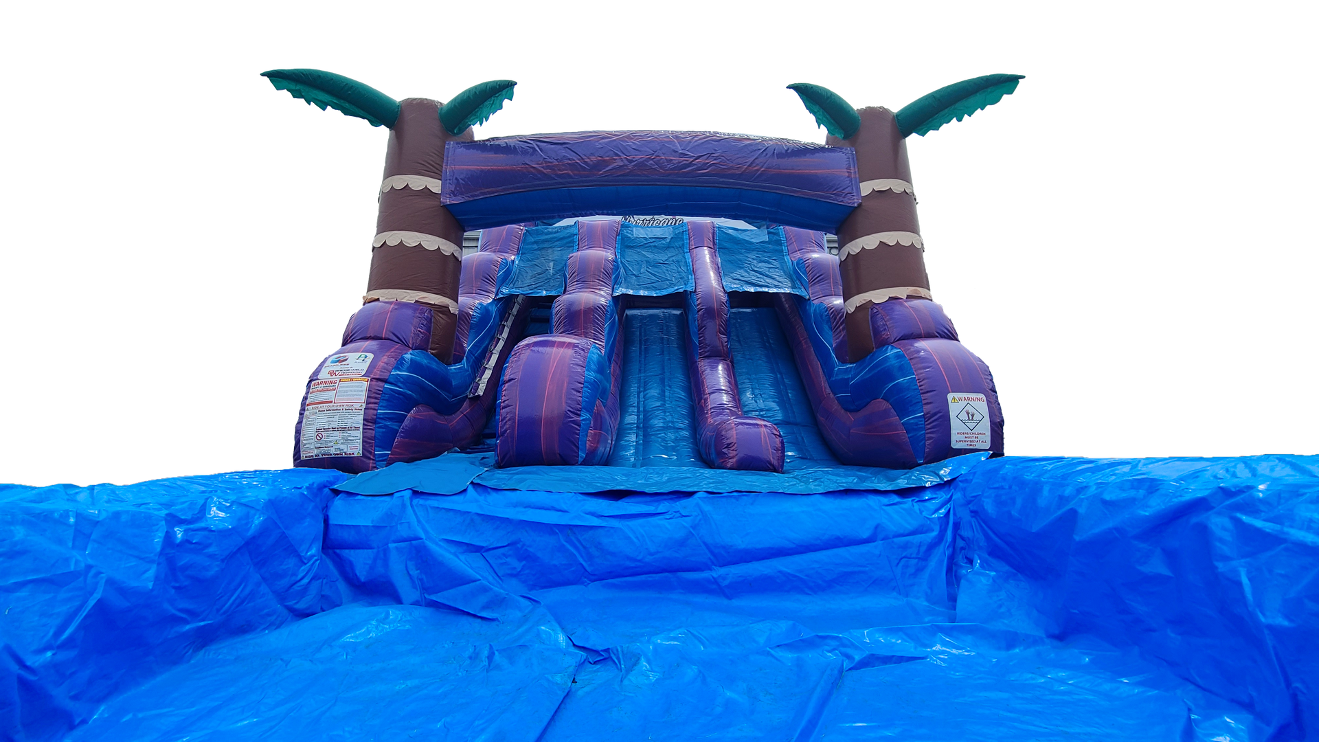 A large inflatable water slide with palm trees on top of it.