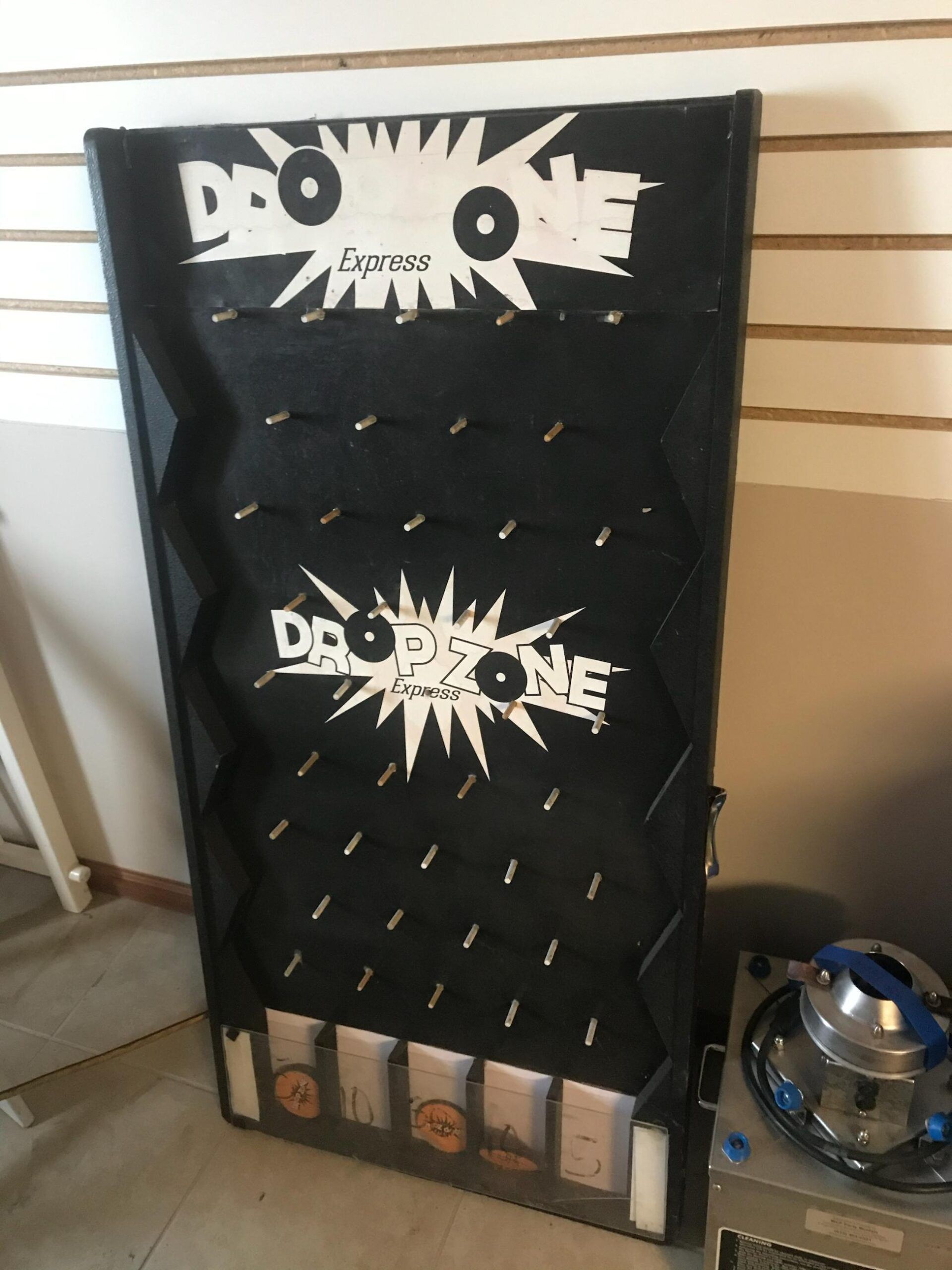 A black board with the words drop one on it