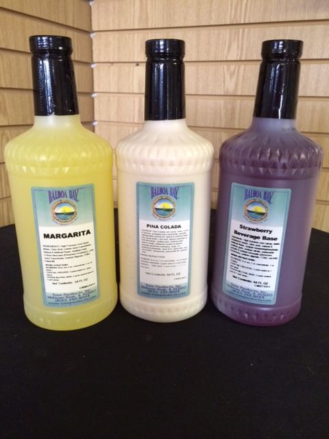 Three bottles of liquor one of which is margarita