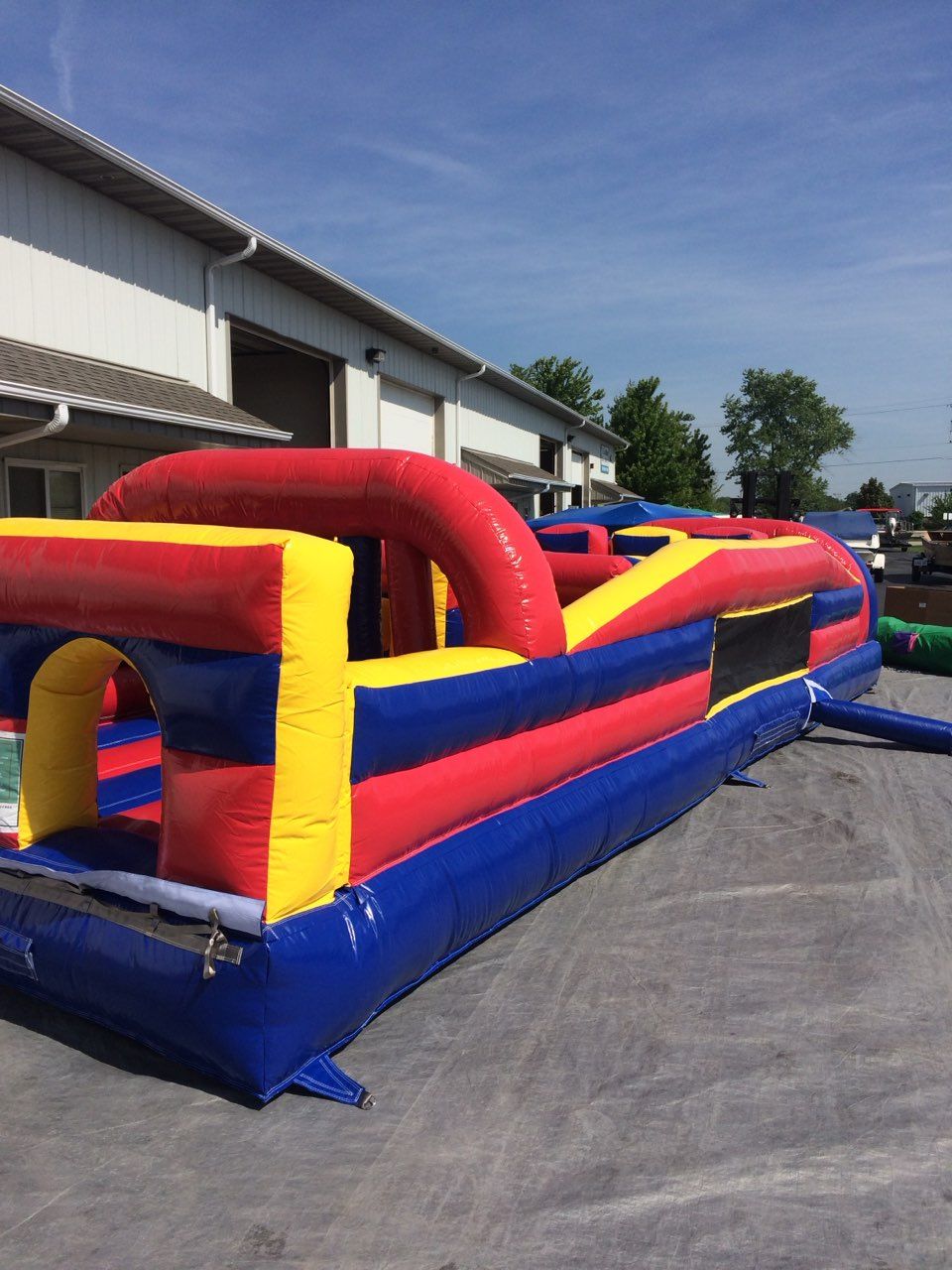 A large inflatable obstacle course is sitting in front of a building.