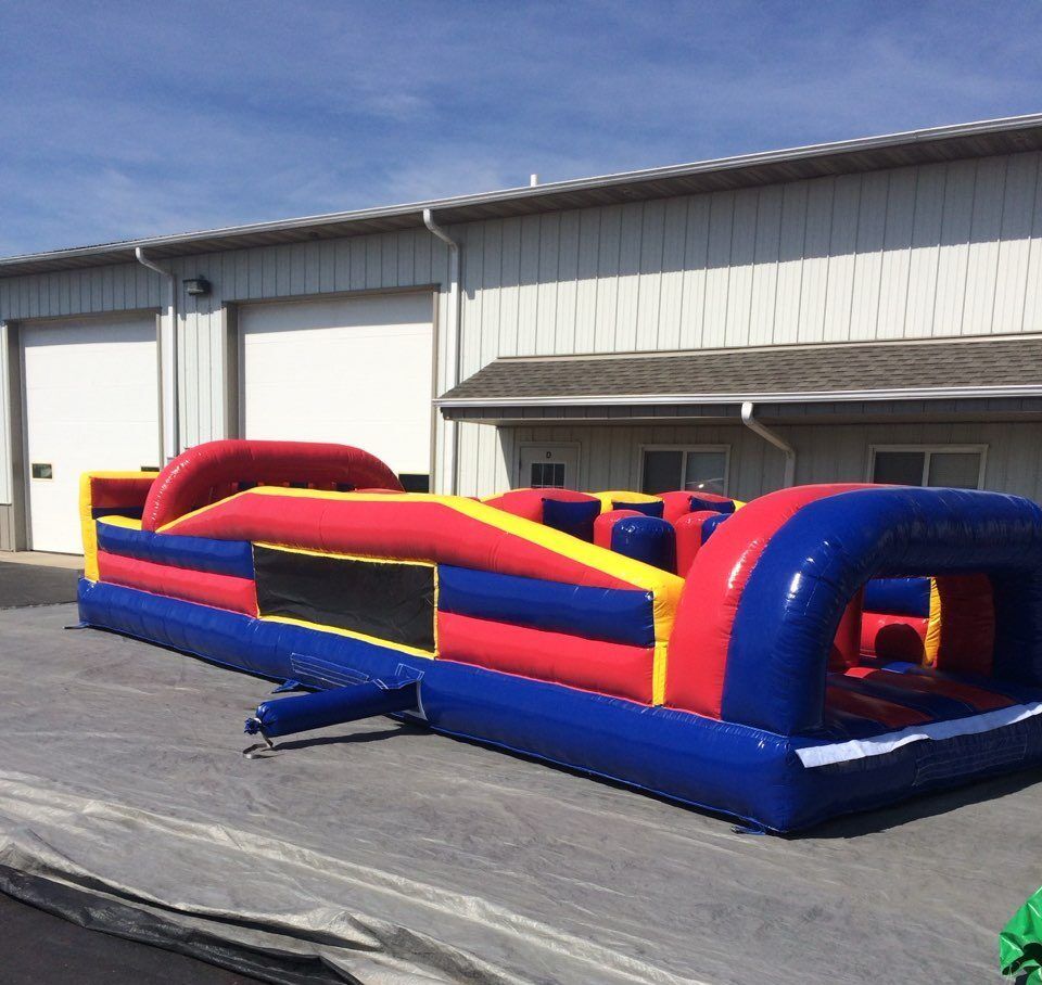 An inflatable obstacle course is sitting in front of a building