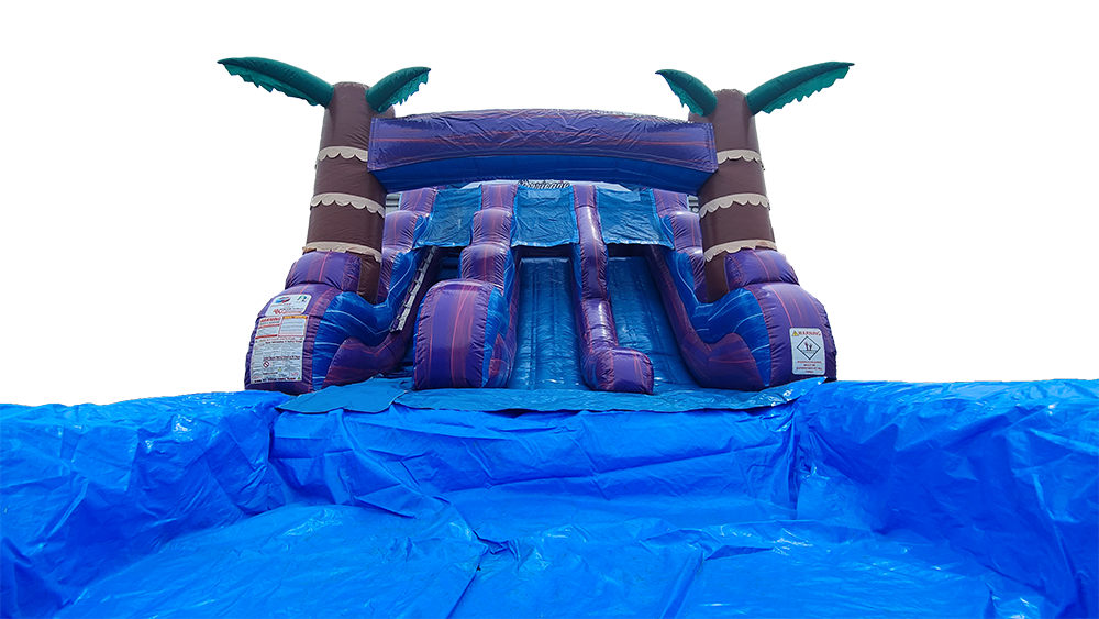 A large inflatable water slide with palm trees on top of it.