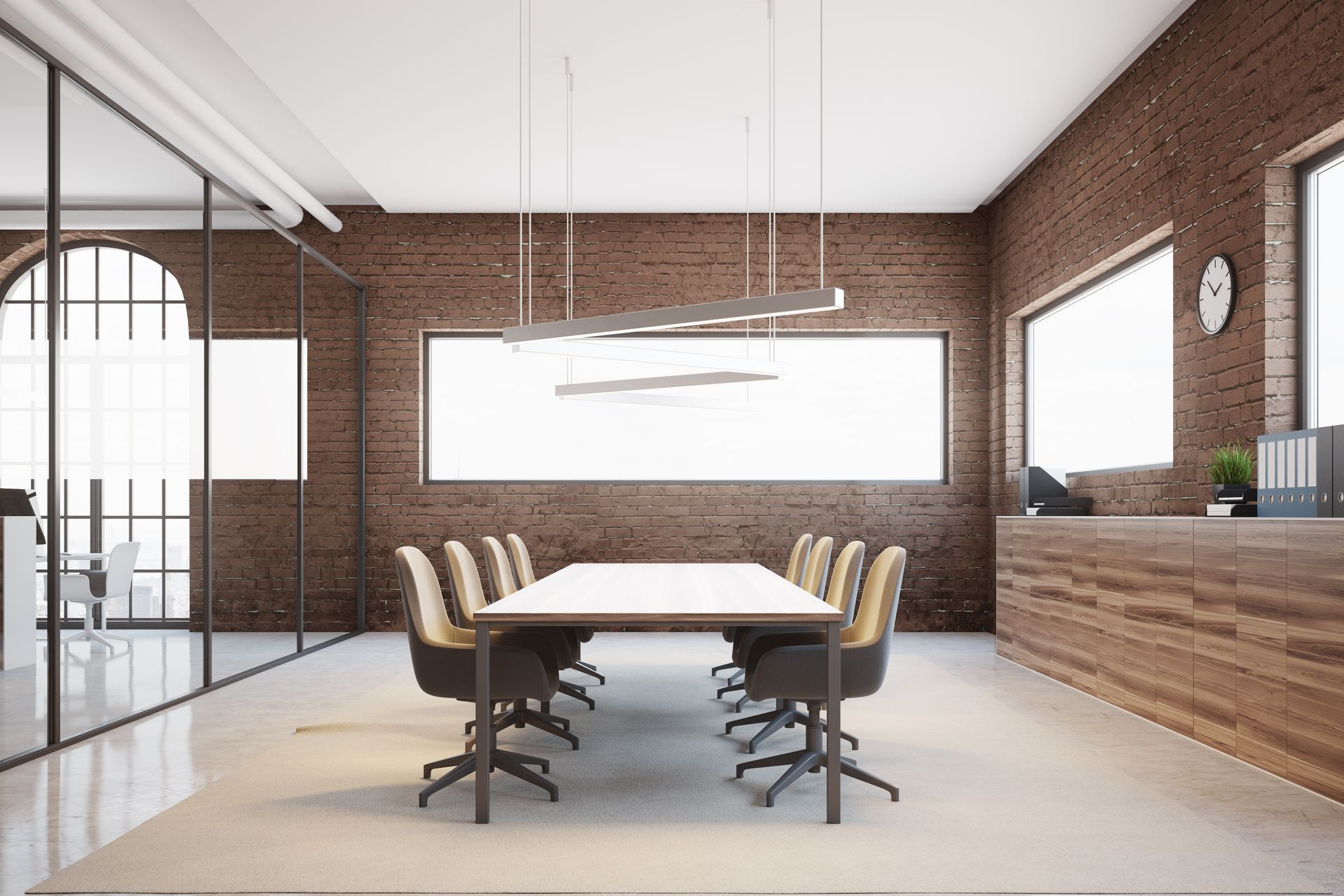 Modern conference room with long table, rolling chairs, brick walls, and large windows