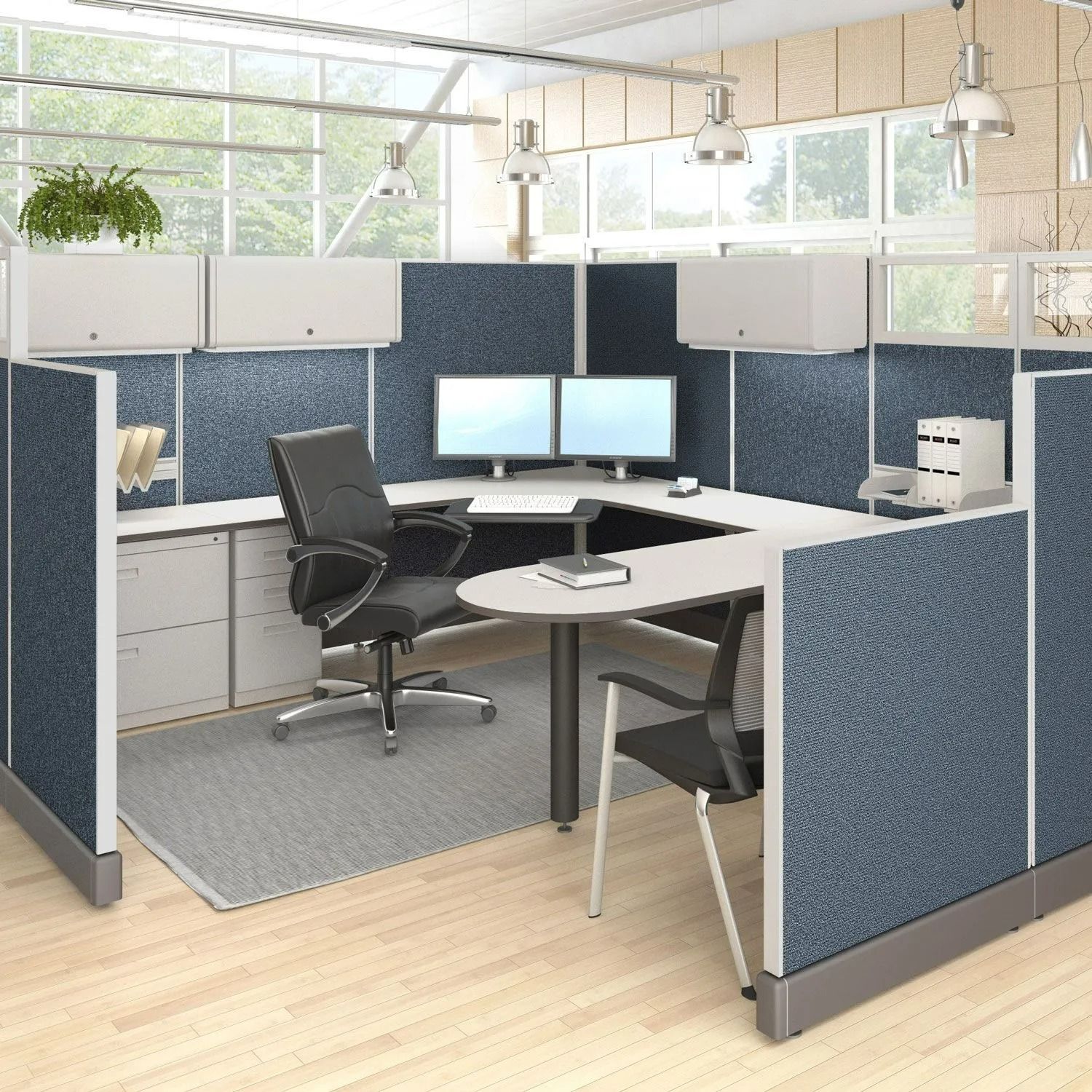 Modern office cubicle with desk, dual monitors, chair, and blue-gray privacy panels