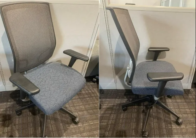 Gray office chair shown from the front and side against a beige wall.