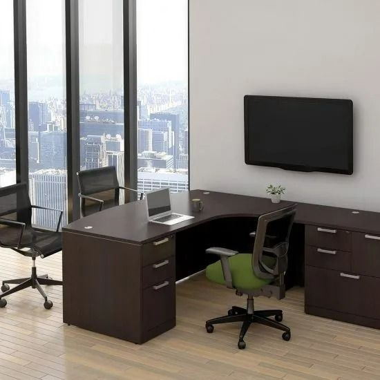 Modern office with L-shaped desk, rolling chairs, wall-mounted TV, and large city-view windows.