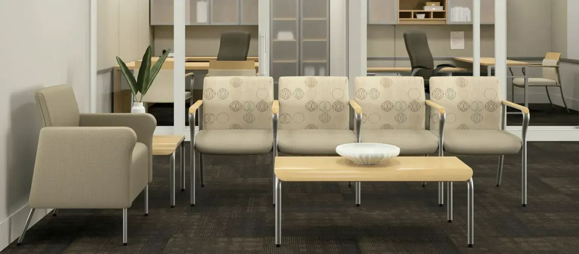 Modern waiting room with beige chairs, a wooden coffee table, and shelves in the background