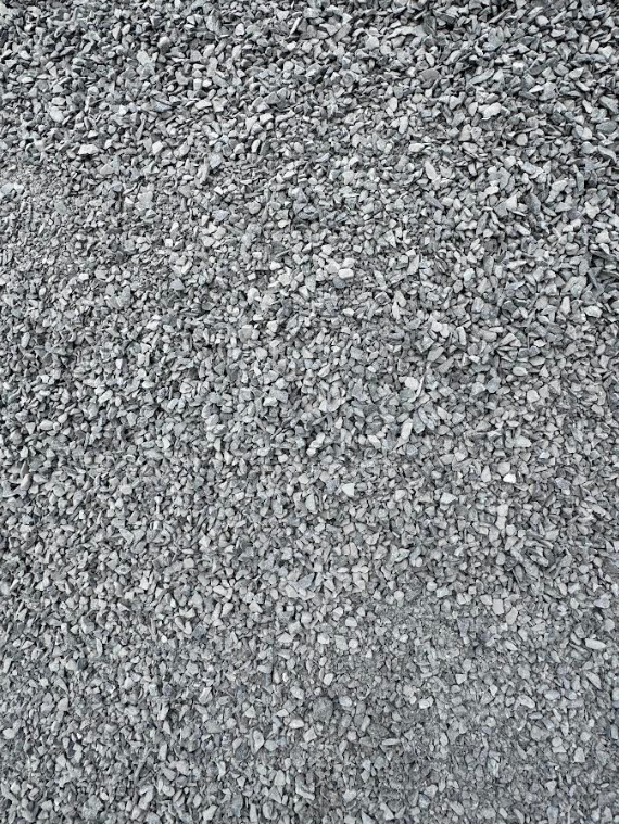Close-up of gray pebbled gravel texture covering the frame