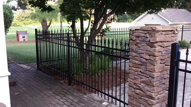 Decorative ornamental iron fence in a backyard