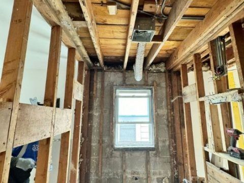 A room with wooden beams and a window in it.
