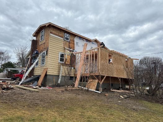 A house is being remodeled in a backyard.