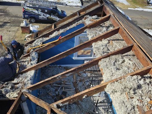 A man is working on the roof of a house.