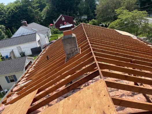 The roof of a house is being built with wooden beams.