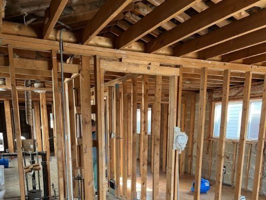 The inside of a house being built with wooden beams.