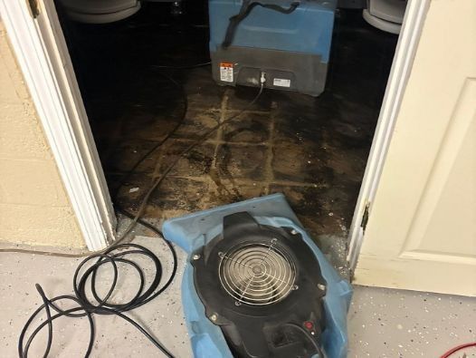 A fan is sitting in a blue bag in a bathroom
